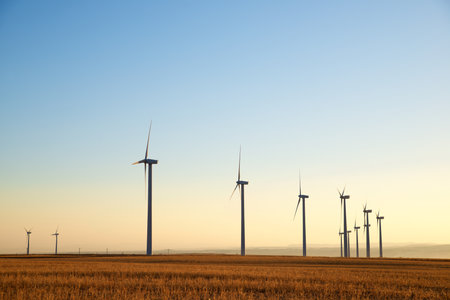 Wind turbine generators for sustainable electrical energy production at sunriseの写真素材