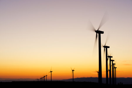 Wind turbine generators for sustainable electrical energy production at sunriseの写真素材