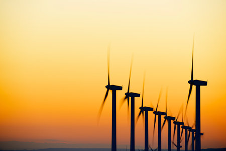Wind turbine generators for sustainable electrical energy production at sunriseの写真素材