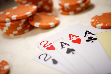 Close up of a group of casino chips and poker cards on a surface