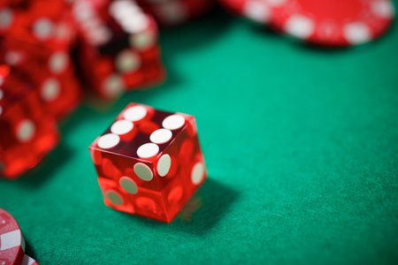 Close up of a group of red dice on a green matの写真素材