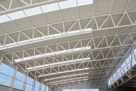Close-up view from below of the roof trusses of a sports hallの写真素材