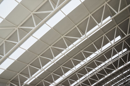 Close-up view from below of the roof trusses of a sports hallの写真素材
