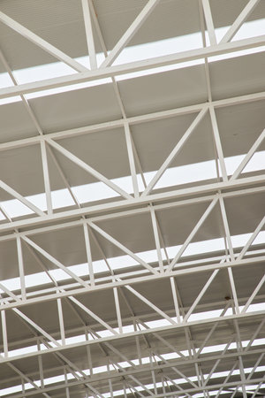 Close-up view from below of the roof trusses of a sports hallの写真素材