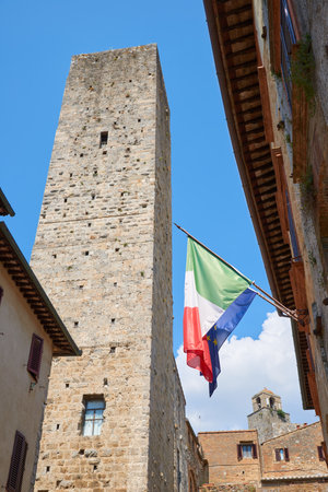 Tower and flags in San Gimignano in Tuscany, Italy.の写真素材