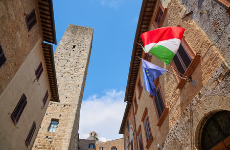Tower and flags in San Gimignano in Tuscany, Italy.の写真素材