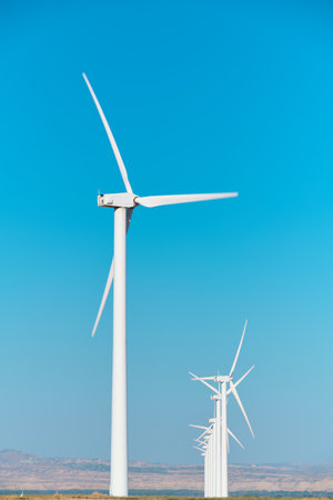 Windmills for renewable electrical production and clear skyの写真素材