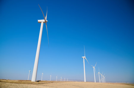 Windmills for renewable electrical production and clear skyの写真素材