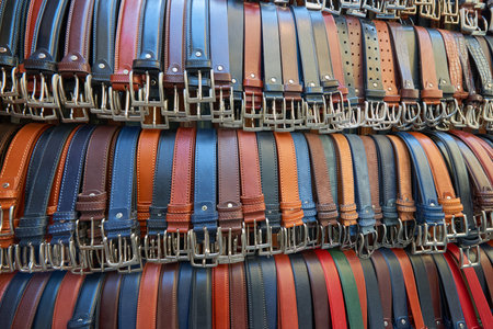 Close up of a group of men's leather belts made in Italy, for sale at a street market, Florence, Italy.の写真素材