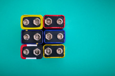 Close-up of a rectangular nine-volt batteries on a green table.の写真素材