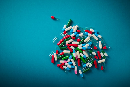 Close up of a group of colourful pills on a blue table