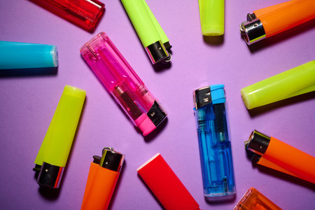 Close-up of a group of lighters of various colors used by smokers