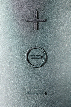 Close-up of the rubber volume control knobs on a wireless speaker. Sound music control buttons concept.