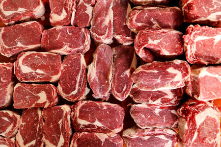 many Ancho or Ribeye steak on a wooden background for a Brazilian barbecue.