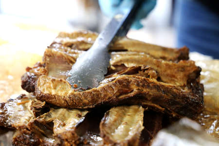 Rib. Delicious roast rib with big bones. Served on a wooden board.の写真素材