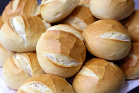 lots of golden burger buns. round bread in a basket.