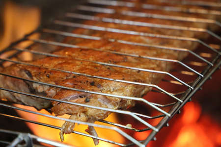 Ribs pork in brazilian barbecue. With fire background. Close up.の写真素材