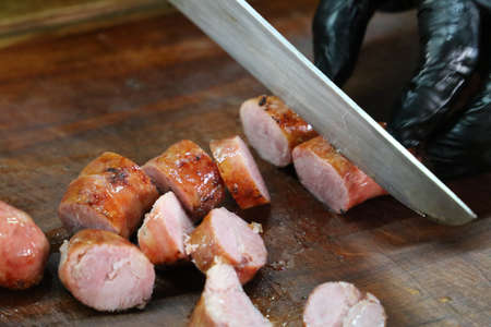 sausage sliced ââââon a rustic wooden board. Brazilian barbecue.の写真素材