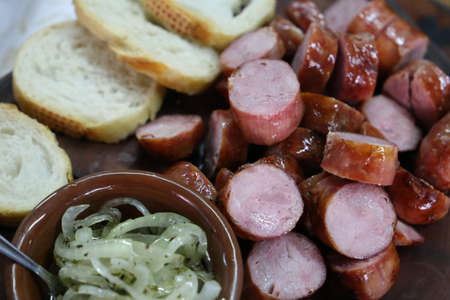 bread with sausage and chimichurri on a wooden board. Brazilian barbecue.の写真素材