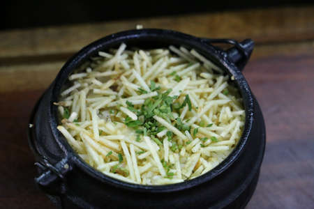 brazilian Rice Food in BBQ. With potato and bacon. Beautiful pots and background...