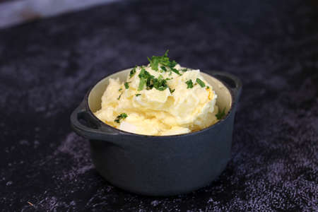 mayonnaise salad with potatoes and parsley. In a small black pot. Brazilian food.の写真素材