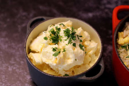 mayonnaise salad with potatoes and parsley. In a small black pot. Brazilian food.の写真素材