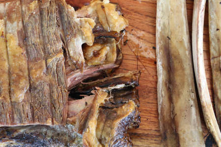Rib. Delicious roast rib with big bones. Served on a wooden board.