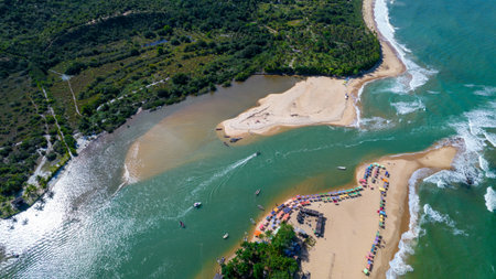Aerial view of Caraiva beach, Porto Seguro, Bahia, Brazil. Colorful beach tents, sea and river.の写真素材