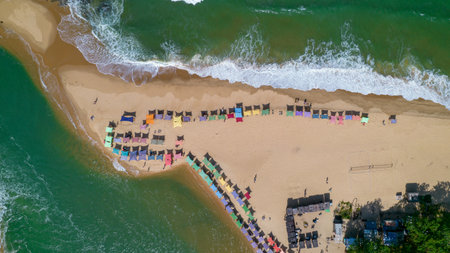 Aerial view of Caraiva beach, Porto Seguro, Bahia, Brazil. Colorful beach tents, sea and river.の写真素材