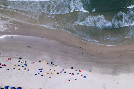 This coastal landscape features Praia da Pitangueiras in Guaruja, Sao Paulo, where clear blue waters...