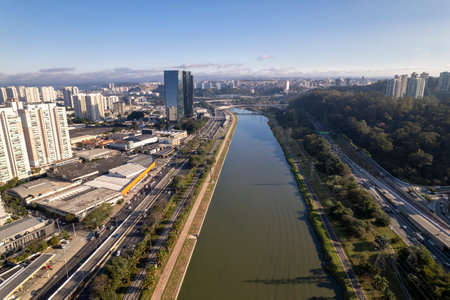 The vibrant park is seen from above, bordered by the Marginal Pinheiros, with the bustling commercial buildings of SÃ£o Paulo creating a stunning urban backdrop.の写真素材
