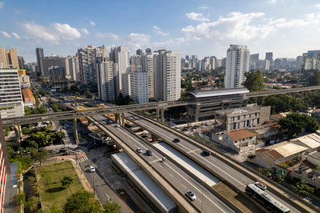This vibrant aerial panorama captures Campo Belo in SÃ£o Paulo with its mix of modern high-rises and residential areas, set against a clear blue sky.の写真素材
