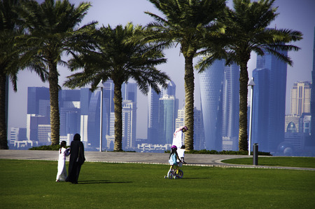 Doha, QATAR -DECEMBER 25, 2016: Family walks near the Museum of Islamic Arts (MIA) with his modern architecture in the city center of Doha, the capital of Qatar in the Gulf Area.のeditorial素材