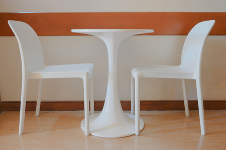 white chair in an empty room with wooden floor.の写真素材