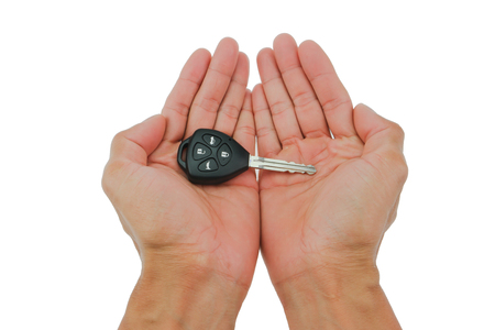 Hand the car keys on isolate white backgroundの写真素材