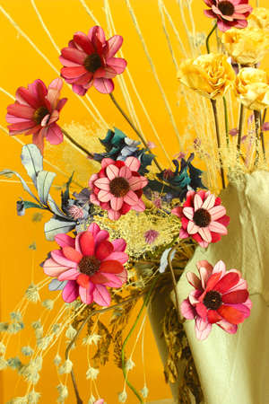 Artificial flowers bright and beautiful colors in vaseの写真素材