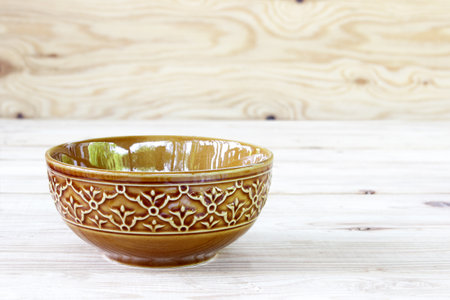 Empty ceramic bowl on wooden table