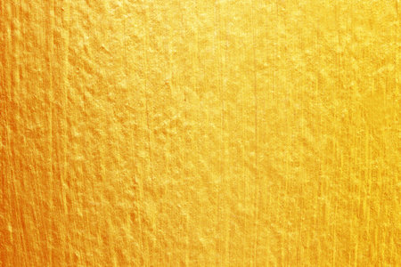 Gold paint on cement wall texture. golden texture background