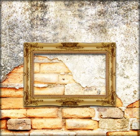 old gold antique picture frame on the old brick wall backgroundの写真素材