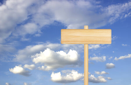 Wood sign and blue sky with white clouds.の写真素材