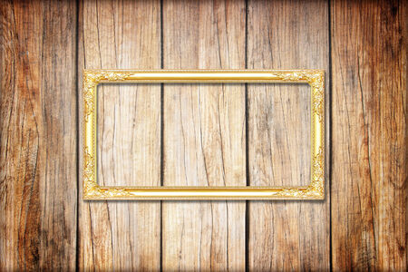 golden frame on Wood wall backgroundの写真素材