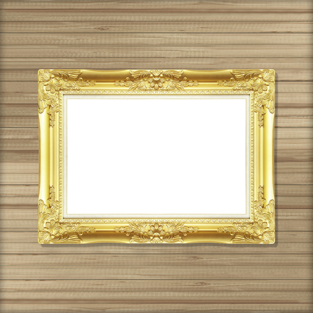 Antique gold frame on wooden wall ;. Empty picture frame on wooden wall.の写真素材