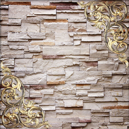 Pattern of wood carve flower on stone wall background ,Pattern of wood carve flower frame on sandstone Brick Wall Surfaced backgroundの写真素材