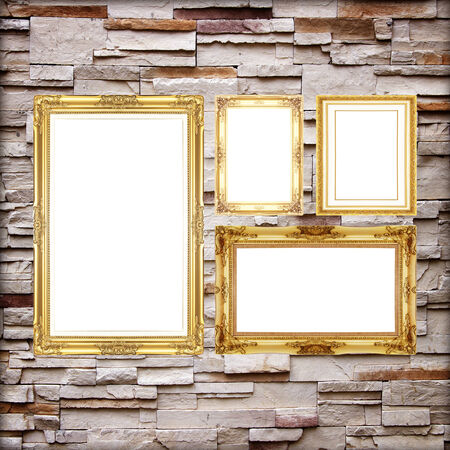 Antique frame on stone wall background ,gold picture frame on sandstone Brick Wall Surfaced backgroundの写真素材
