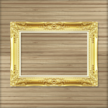 Antique gold frame on wooden wallの写真素材