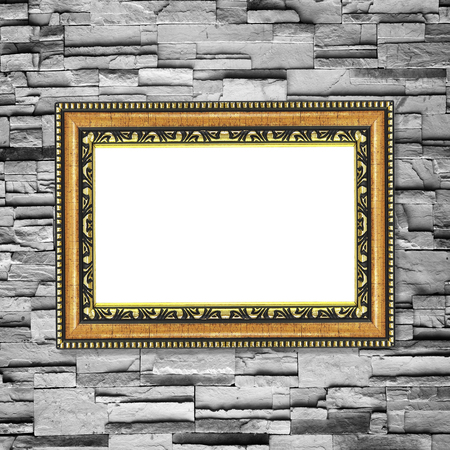 Antique frame on stone wall background ,gold picture frame on sandstone Brick Wall Surfaced backgroundの写真素材