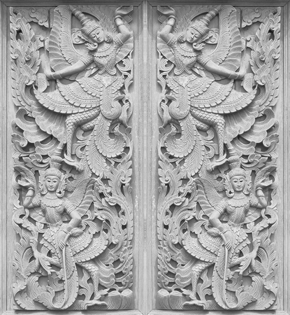 Traditional Thai style wood carving on the wall of Temple in Thailandの写真素材