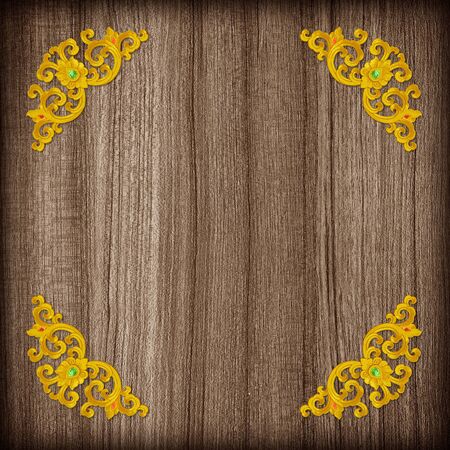 Pattern of gold Stucco flower on wood backgroundの写真素材