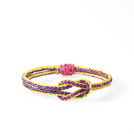 wristband made from woven straw on a white background.の写真素材