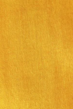 Shiny yellow leaf gold foil texture backgroundの写真素材